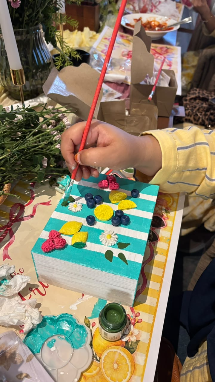 Child painting a fruit bloom box